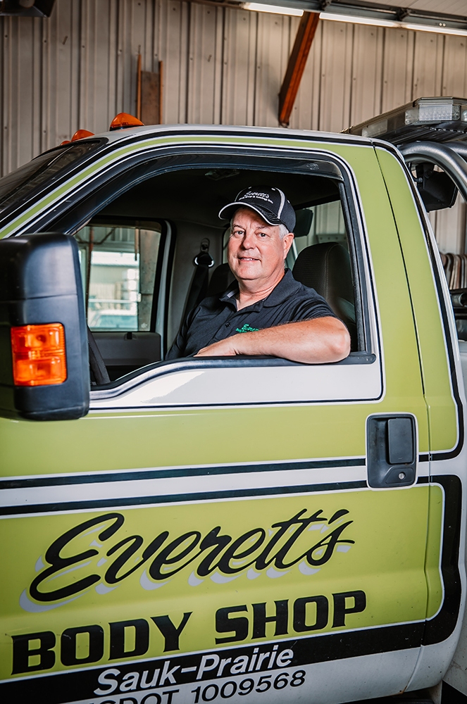 Bryan inside Everett's Body Shop & Towing tow truck